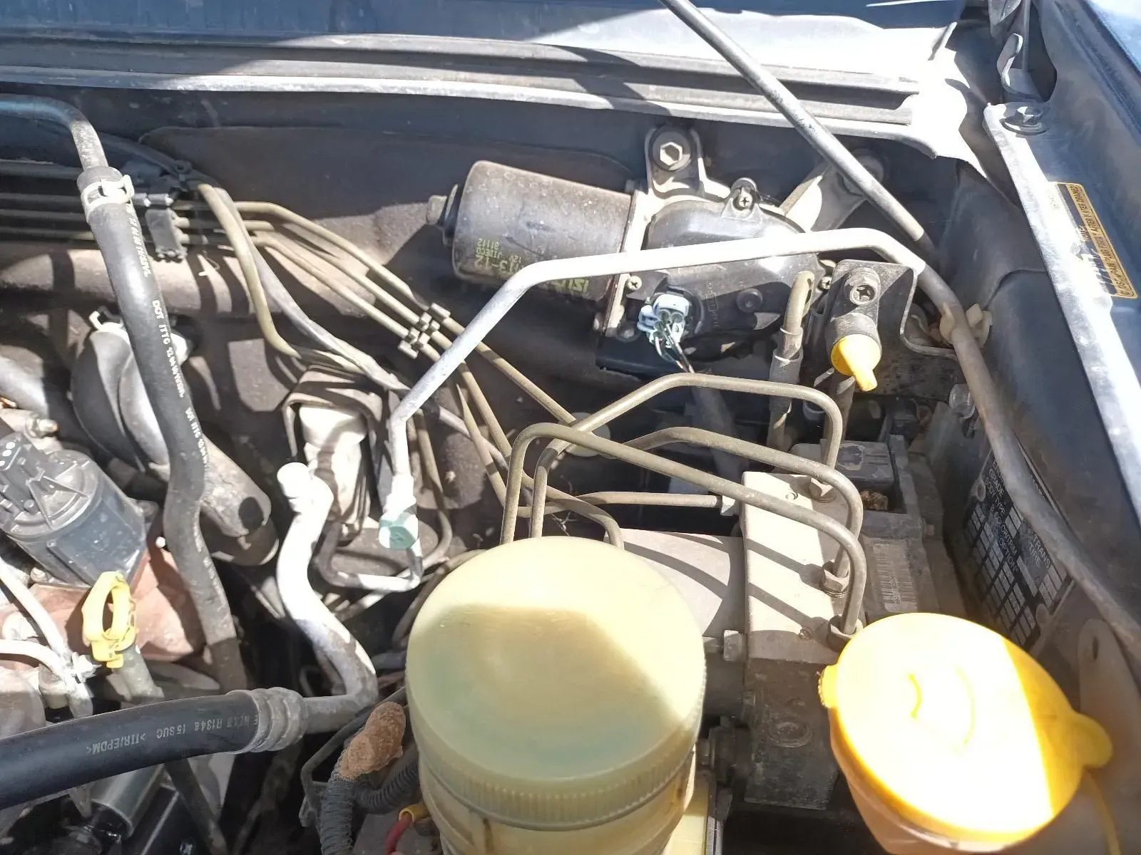 Engine Bay With Various Tubes and Reservoirs, Likely From a Vehicle — South West 4WD Wreckers In Brisbane, QLD