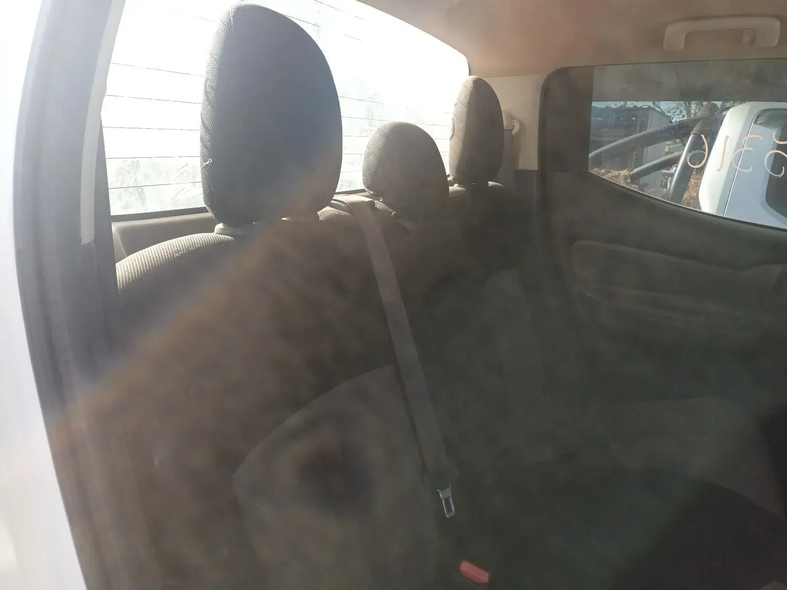 Rear Passenger Seats Inside a White Truck, With Headrests and Seatbelts — South West 4WD Wreckers In Brisbane, QLD