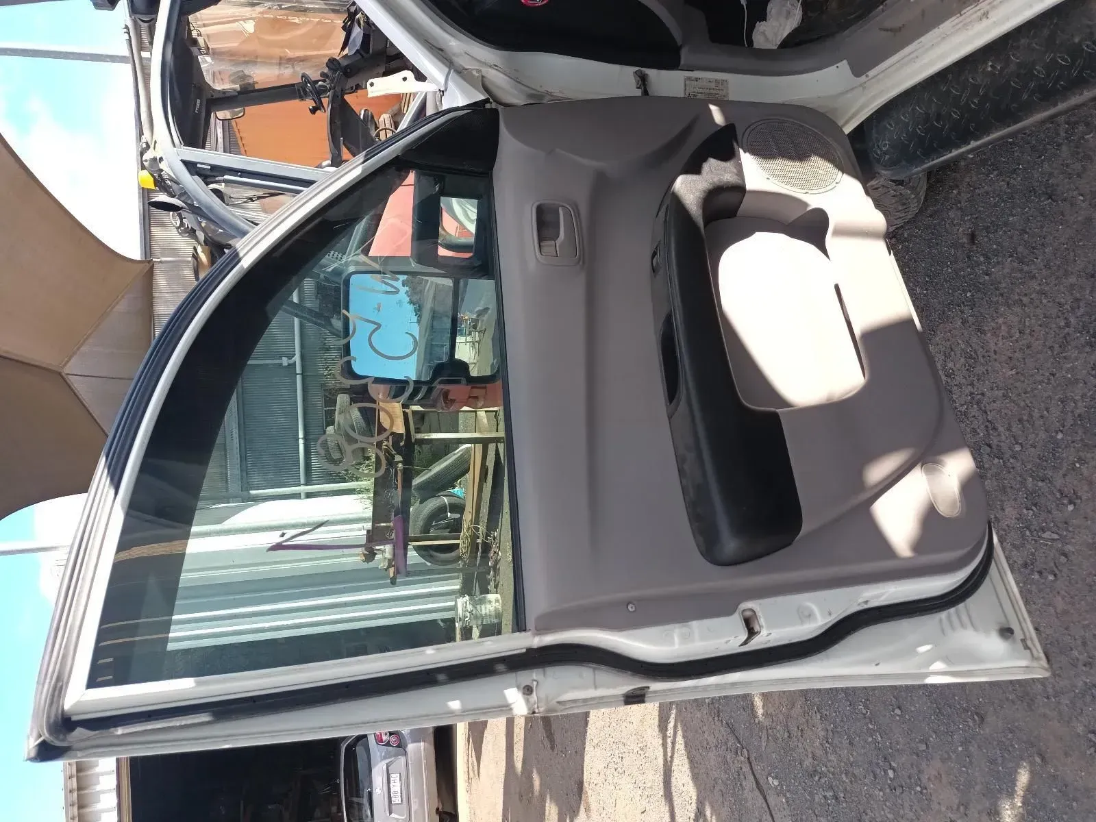 Car Door, White Exterior, Gray Interior Panel, Open in a Salvage Yard — South West 4WD Wreckers In Brisbane, QLD