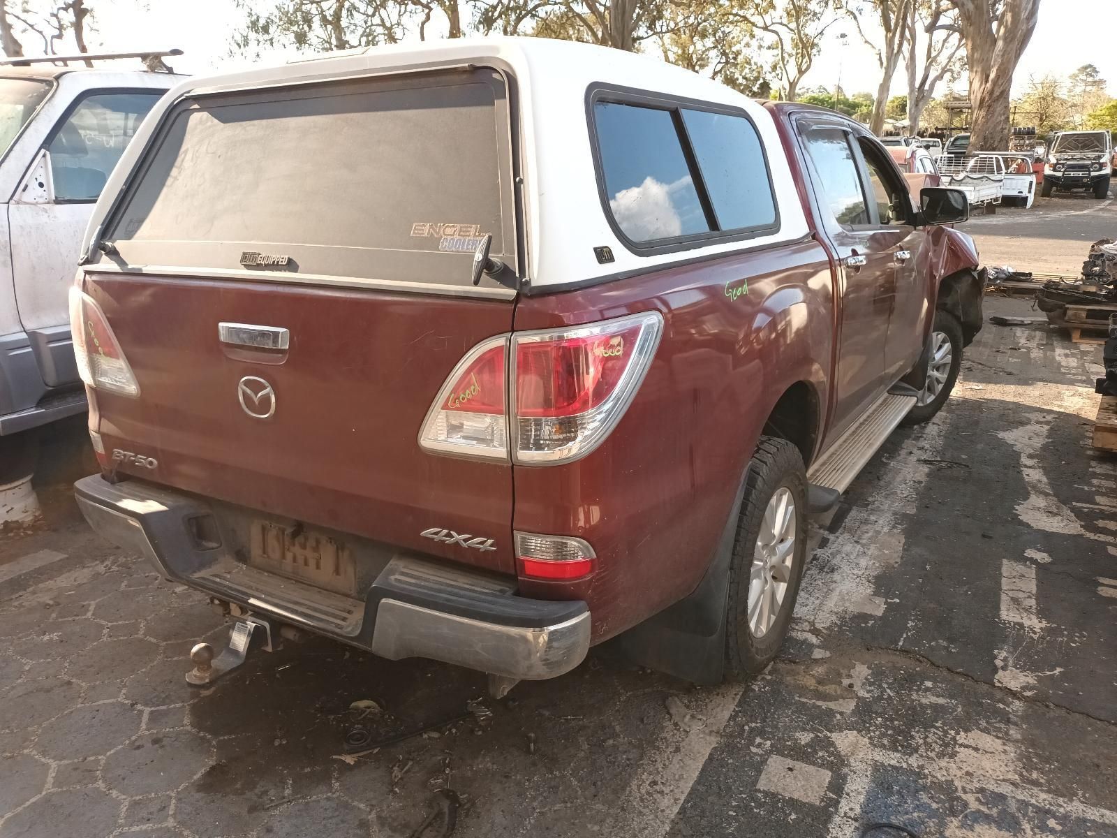 A Red Truck with a White Canopy is Parked  — South West 4WD Wreckers In Brisbane, QLD