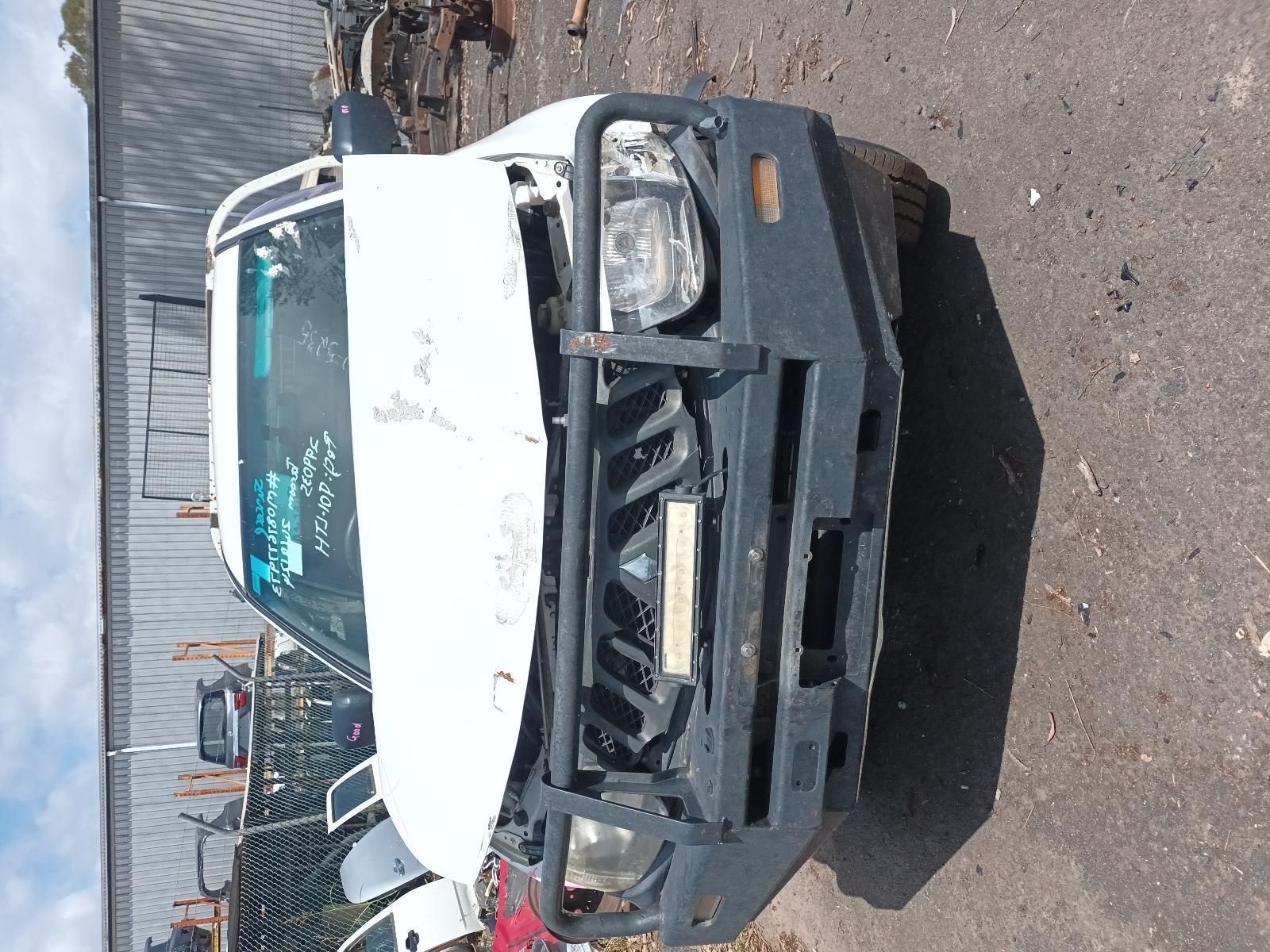 A White Truck with a Black Bumper is Parked on the Side of the Road — South West 4WD Wreckers in Harristown, QLD