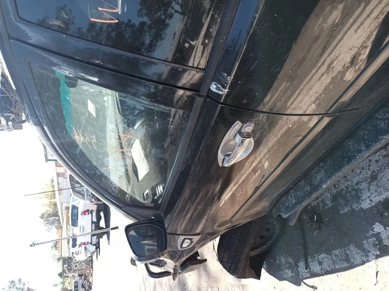 Black Car, Driver's Side Door Slightly Ajar, Parked Near Other Vehicles — South West 4WD Wreckers In Brisbane, QLD