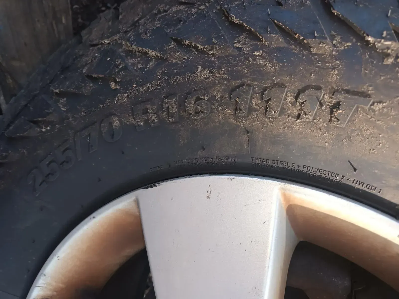 Close-up of a Dirty Tyre With Visible Tread, Part of a Silver Rim Visible — South West 4WD Wreckers In Brisbane, QLD