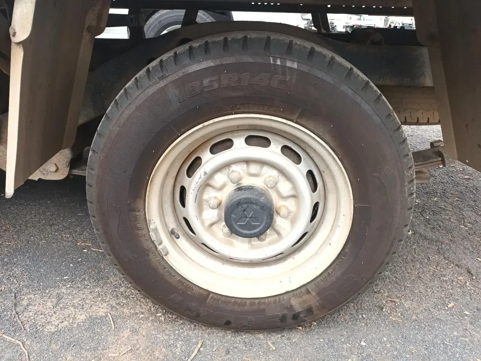 White Truck Tyre and Wheel on Asphalt Ground — South West 4WD Wreckers In Brisbane, QLD