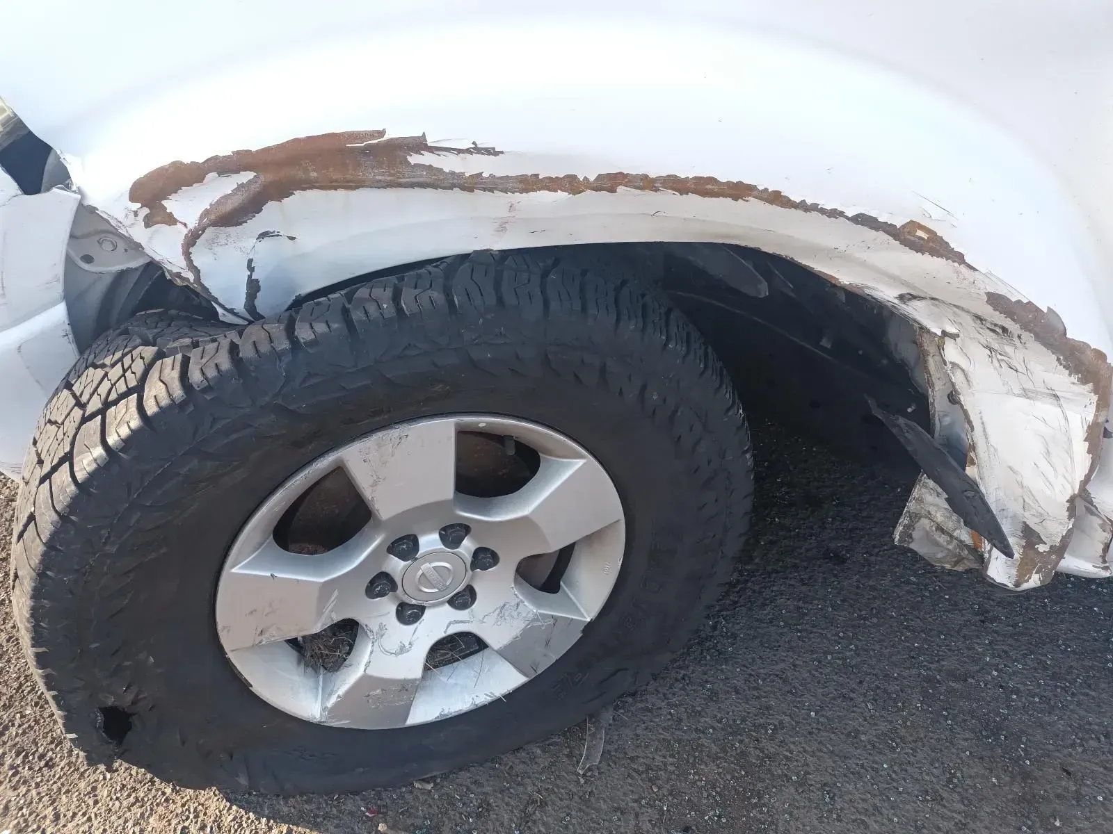 Damaged White Car Wheel, Fender Crumpled and Paint Peeling, Flat Tyre — South West 4WD Wreckers In Brisbane, QLD