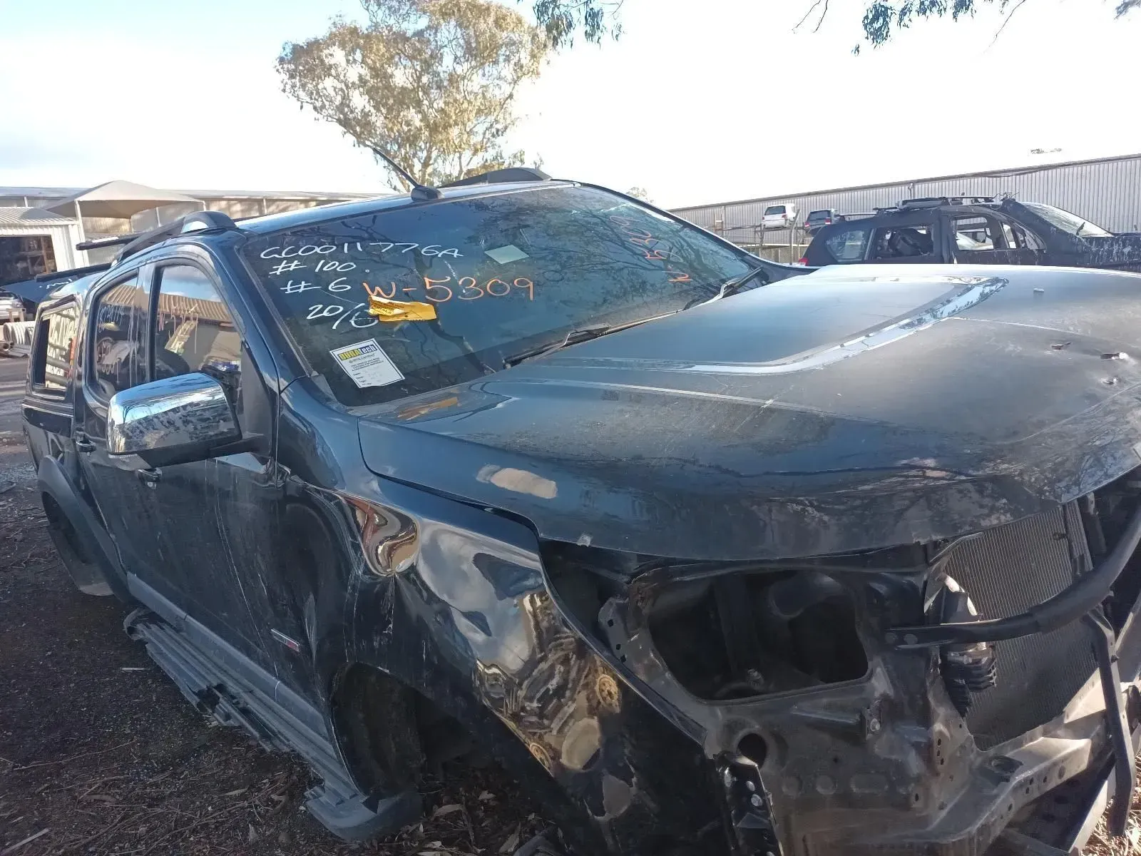 Damaged Black Pickup Truck in a Salvage Yard — South West 4WD Wreckers In Brisbane, QLD