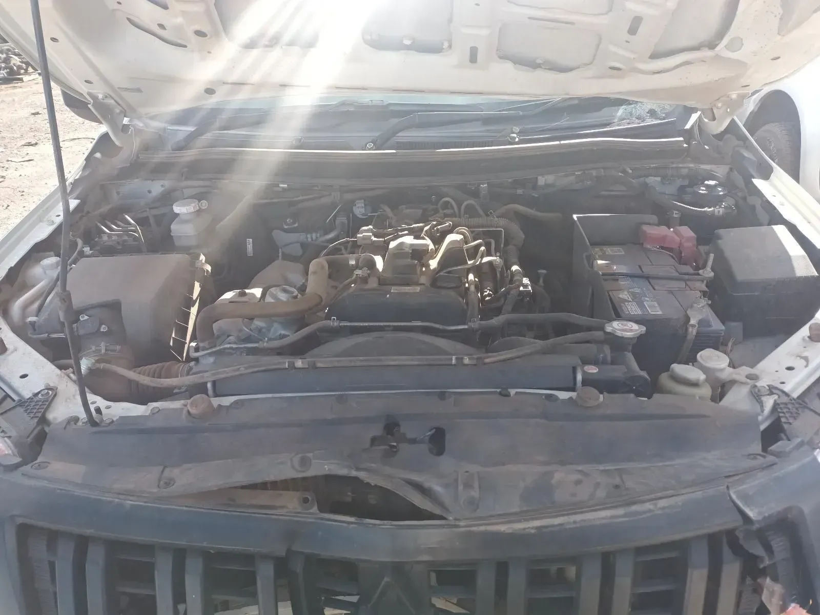 Open Car Hood Reveals a Dusty Engine Bay With a Black Engine — South West 4WD Wreckers In Brisbane, QLD