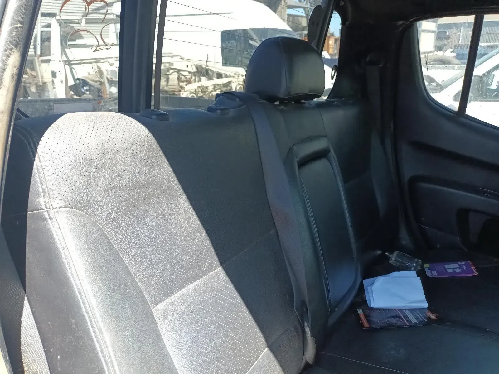 Black Truck Backseat With Headrests and Seat Belts, Likely in a Junkyard — South West 4WD Wreckers In Brisbane, QLD