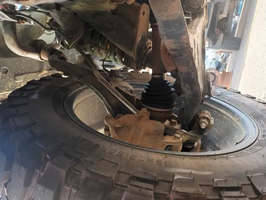 A Close Up of the Underside of a Car with a Tire on It — South West 4WD Wreckers In Brisbane, QLD