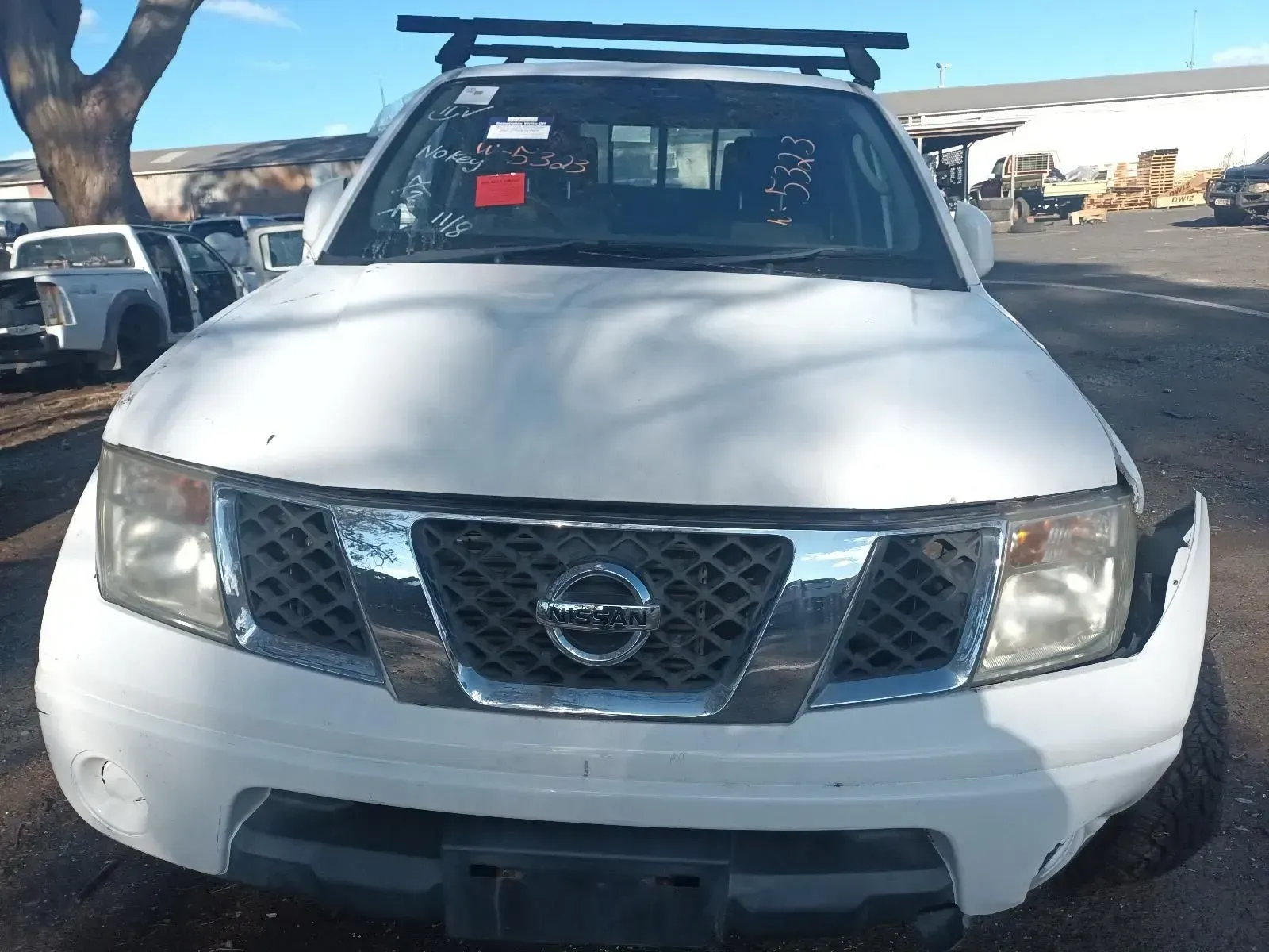 White Nissan Pickup Truck, Front View, in a Junkyard — South West 4WD Wreckers In Brisbane, QLD