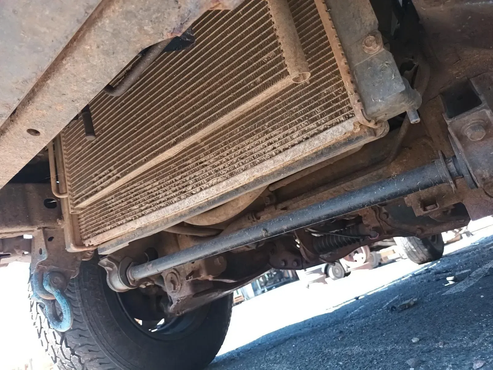 Undercarriage of a Vehicle Showing a Dirty Radiator and Steering Components — South West 4WD Wreckers In Brisbane, QLD