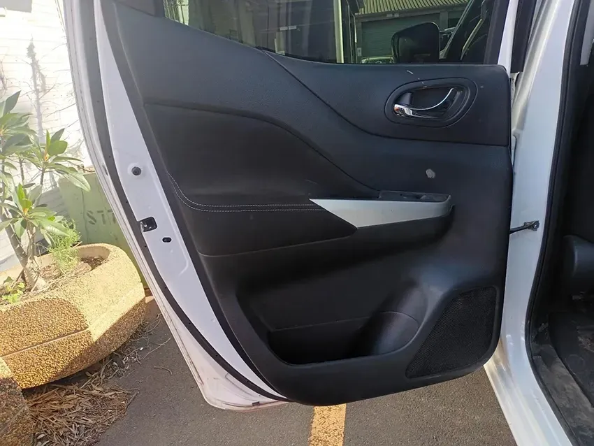 A White Car with the Door Open and a Potted Plant in the Background — South West 4WD Wreckers In Brisbane, QLD