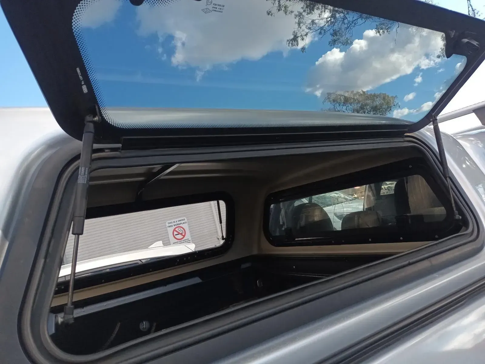 Truck Bed Cover With the Rear Window Open, Revealing the Interior and Sky — South West 4WD Wreckers In Brisbane, QLD