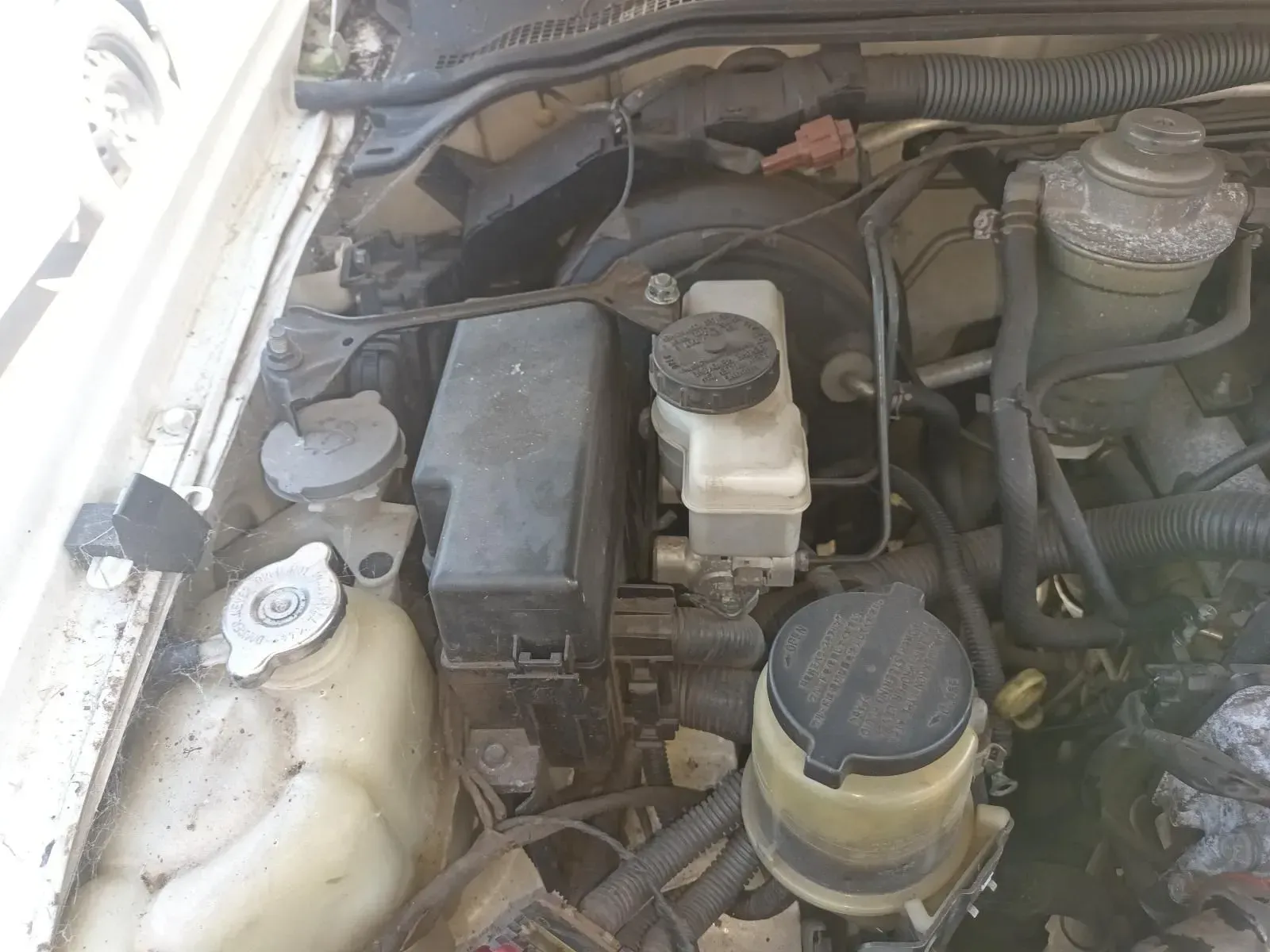 Engine Bay With a Master Cylinder, Fuse Box, and Fluid Reservoirs — South West 4WD Wreckers In Brisbane, QLD