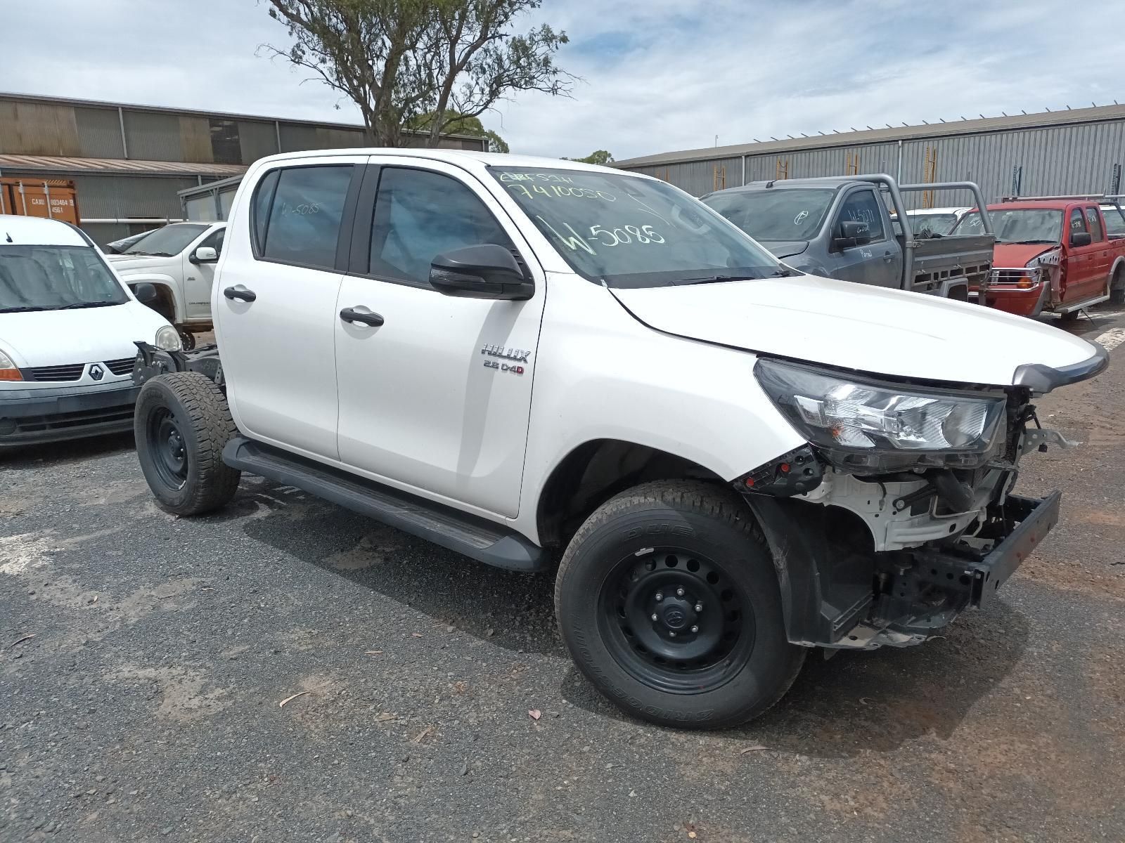 A White Truck is Parked in a Gravel Lot — South West 4WD Wreckers in Harristown, QLD 