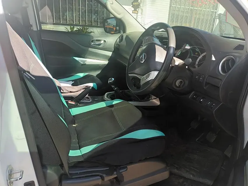 The Interior of a White Car with Black and Green Seats and a Steering Wheel — South West 4WD Wreckers In Brisbane, QLD