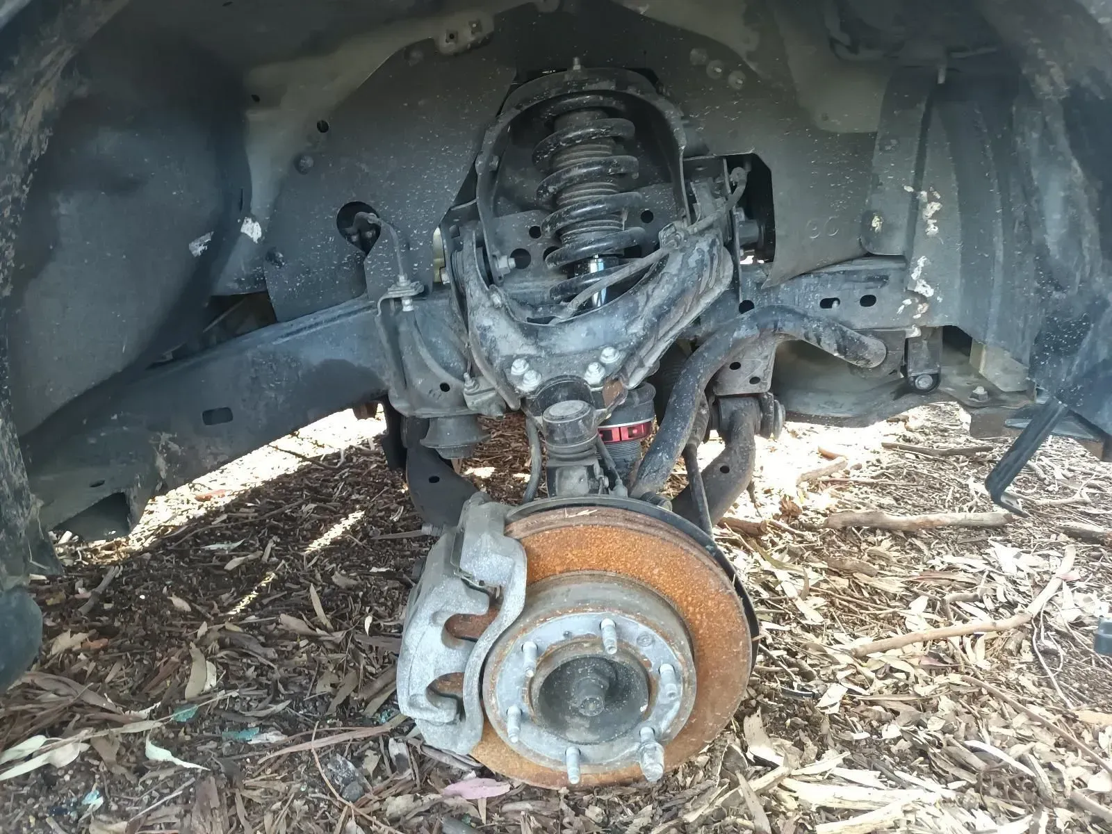 Car Suspension Components Visible, Including Shock Absorber — South West 4WD Wreckers In Brisbane, QLD