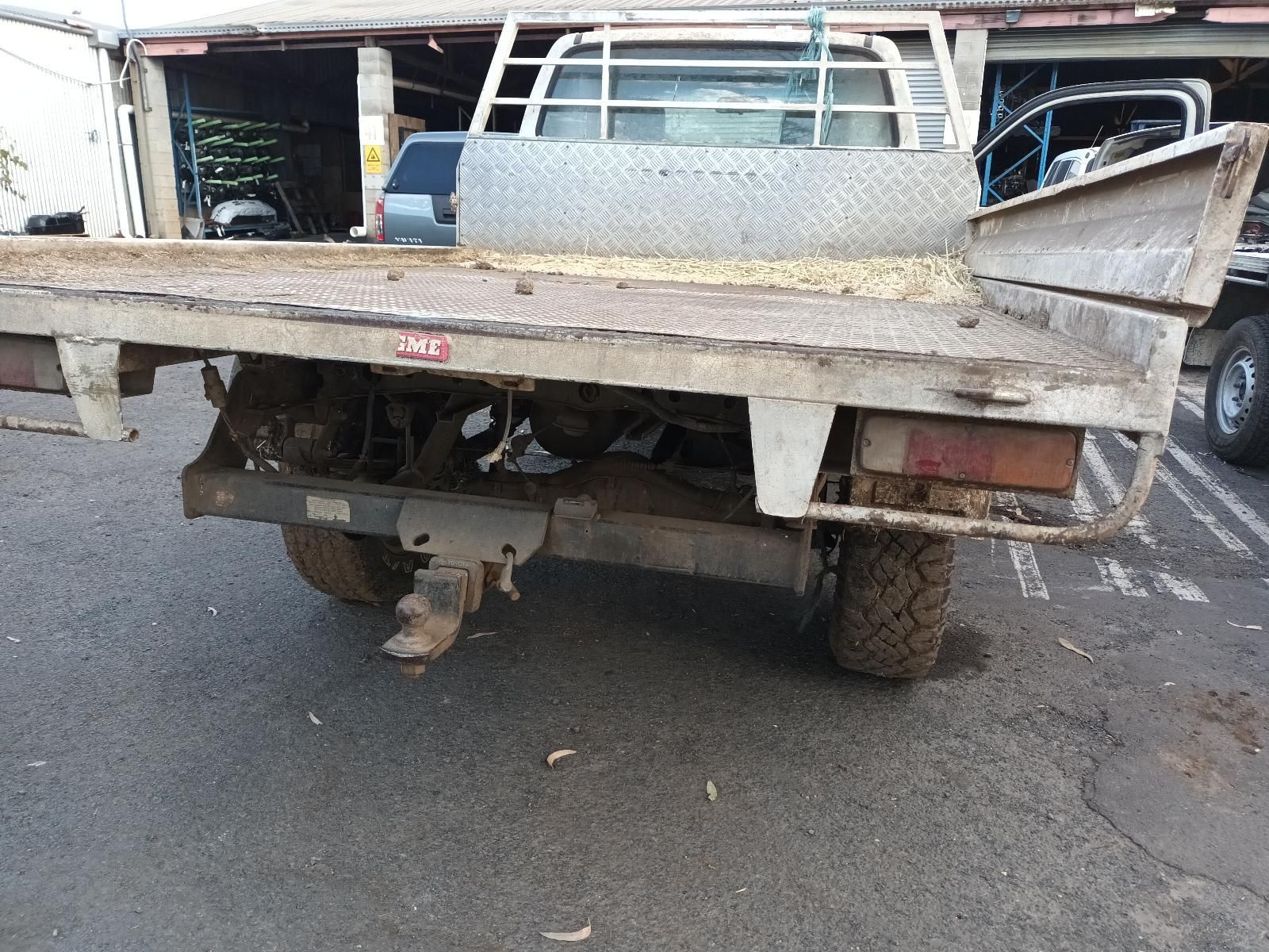 A Truck with a Flat Bed is Parked on the Side of the Road — South West 4WD Wreckers in Harristown, QLD