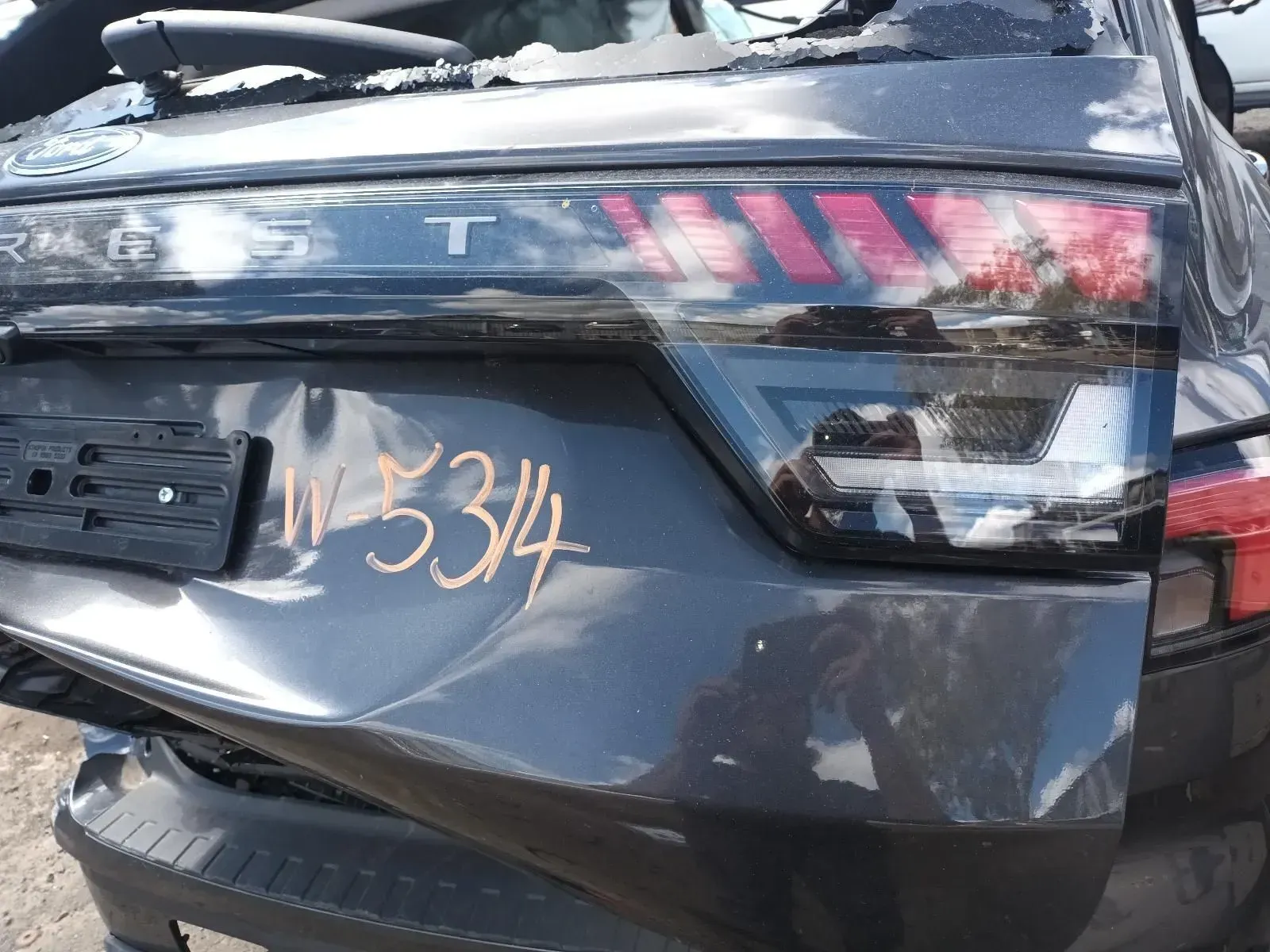 Rear End of a Damaged Black Car With the Taillight on — South West 4WD Wreckers In Brisbane, QLD