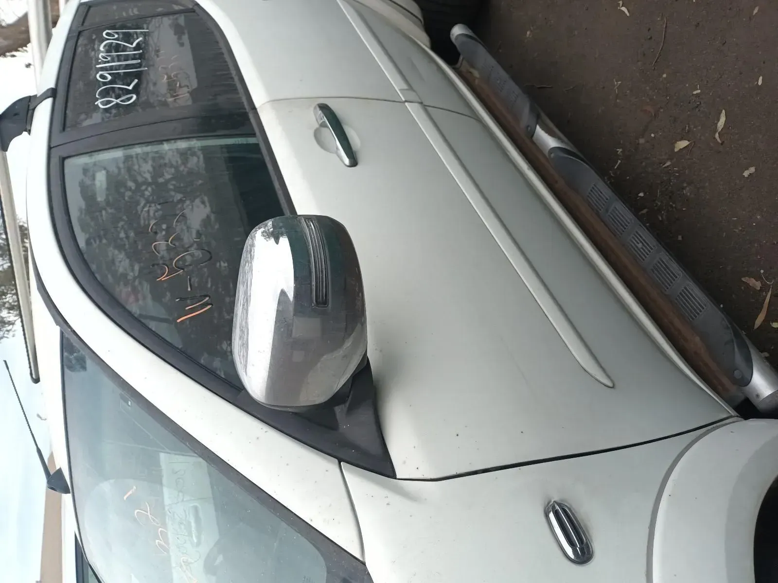 White Car's Side View, Showing Door, Mirror, and Running Board, Parked Outside — South West 4WD Wreckers In Brisbane, QLD
