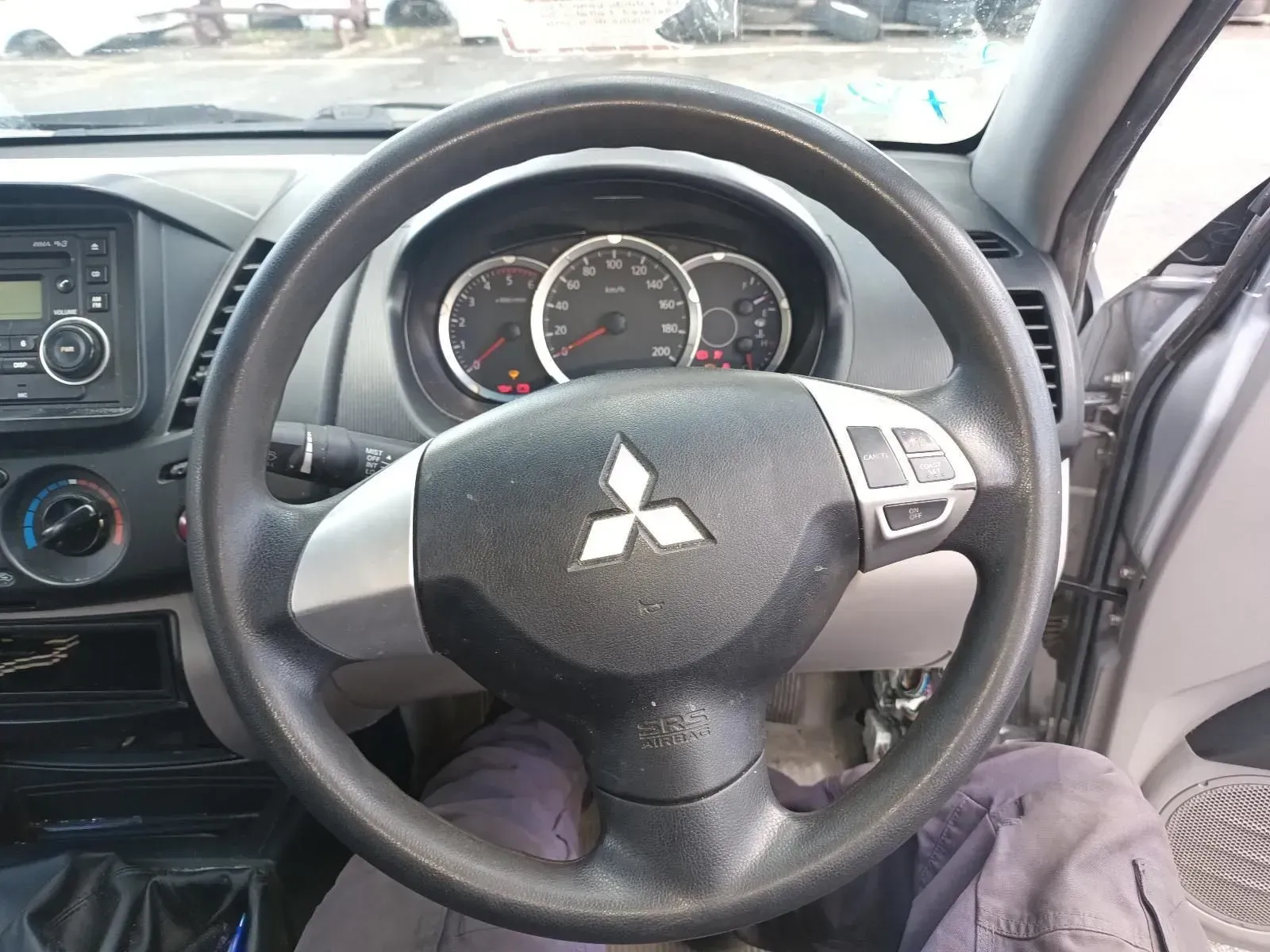 Steering Wheel of a Mitsubishi Vehicle With the Logo in the Center — South West 4WD Wreckers In Brisbane, QLD