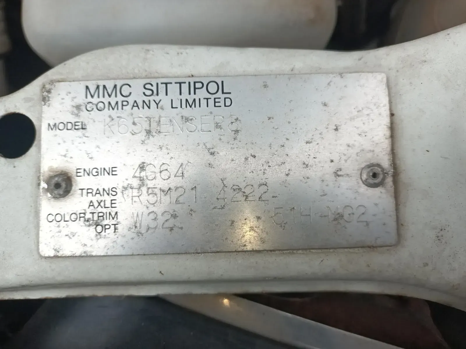 Silver Vehicle Identification Plate on a White Surface — South West 4WD Wreckers In Brisbane, QLD