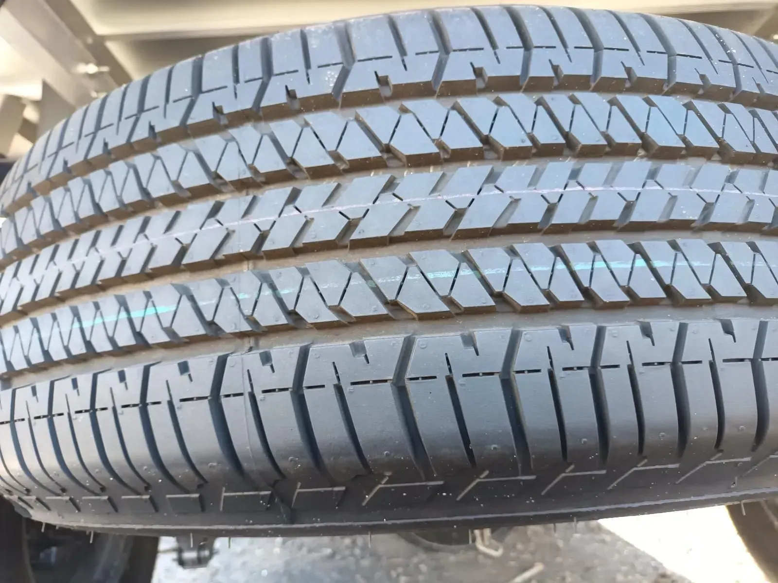 Close-up of a Black Tyre With a Tread Pattern Mounted Under a Vehicle — South West 4WD Wreckers In Brisbane, QLD