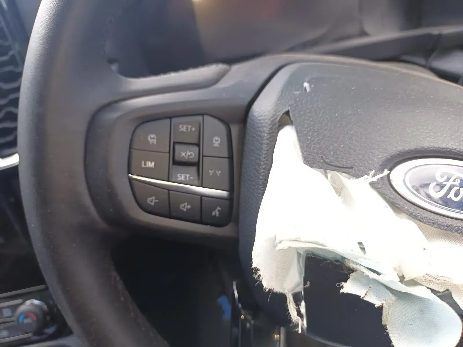 Close-up of a Ford Steering Wheel With Control Buttons and a Deployed Airbag — South West 4WD Wreckers In Brisbane, QLD