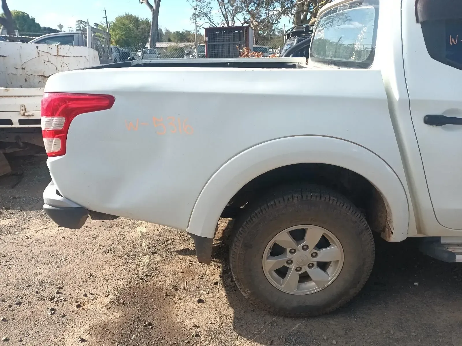 White Pickup Truck With Rear Damage, Parked Outdoors on Dirt — South West 4WD Wreckers In Brisbane, QLD