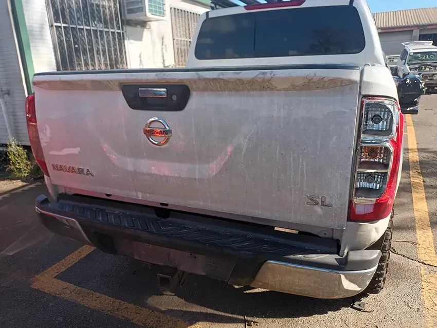 A White Nissan Pickup Truck is Parked in a Parking Lot — South West 4WD Wreckers In Brisbane, QLD