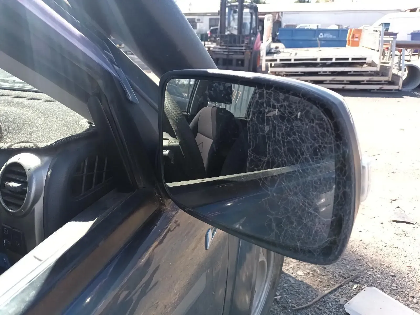 Broken Side-view Mirror on a Gray Car, Showing Shattered Glass — South West 4WD Wreckers In Brisbane, QLD