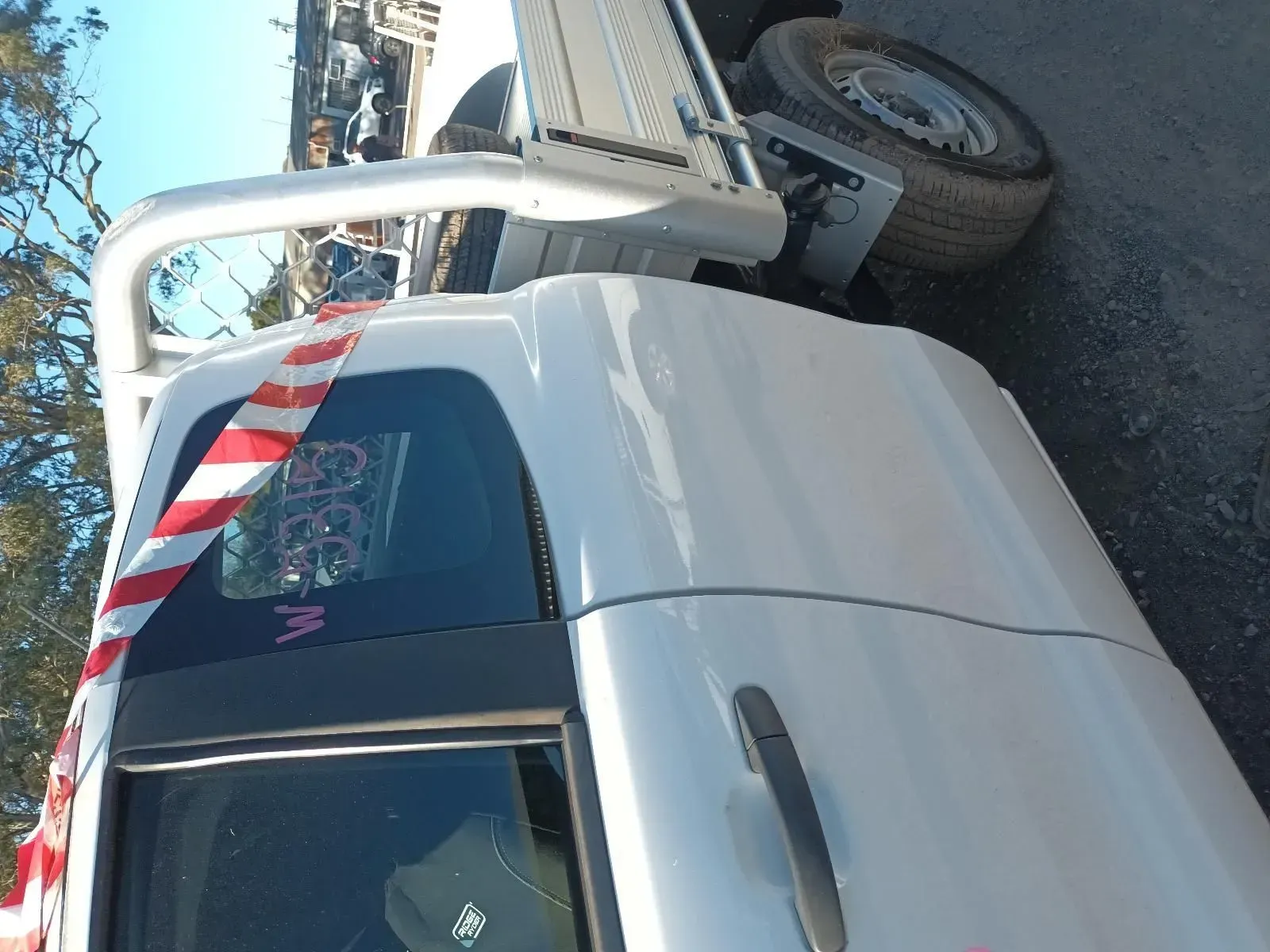 White Truck With a Roll Bar, Red and White Striped Tape on Window — South West 4WD Wreckers In Brisbane, QLD