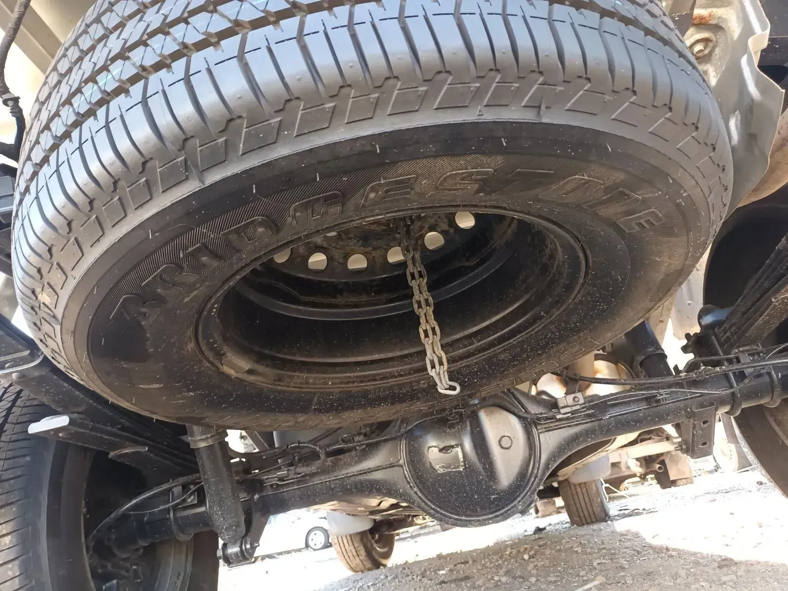 Spare Tyre Mounted Under a Vehicle, Secured by a Chain — South West 4WD Wreckers In Brisbane, QLD