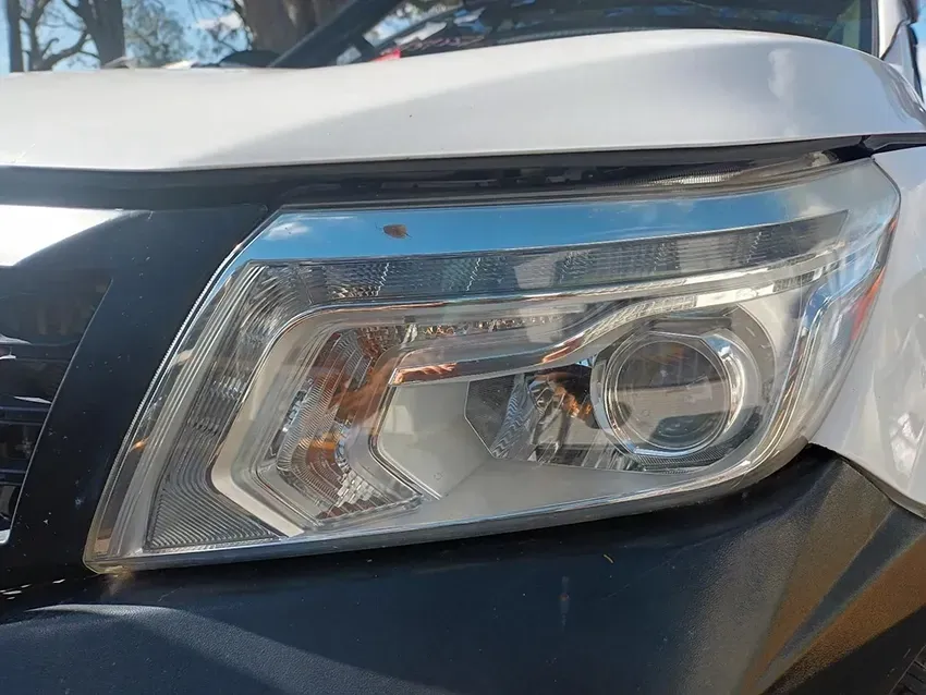 A Close Up of the Headlight of a White Truck — South West 4WD Wreckers In Brisbane, QLD