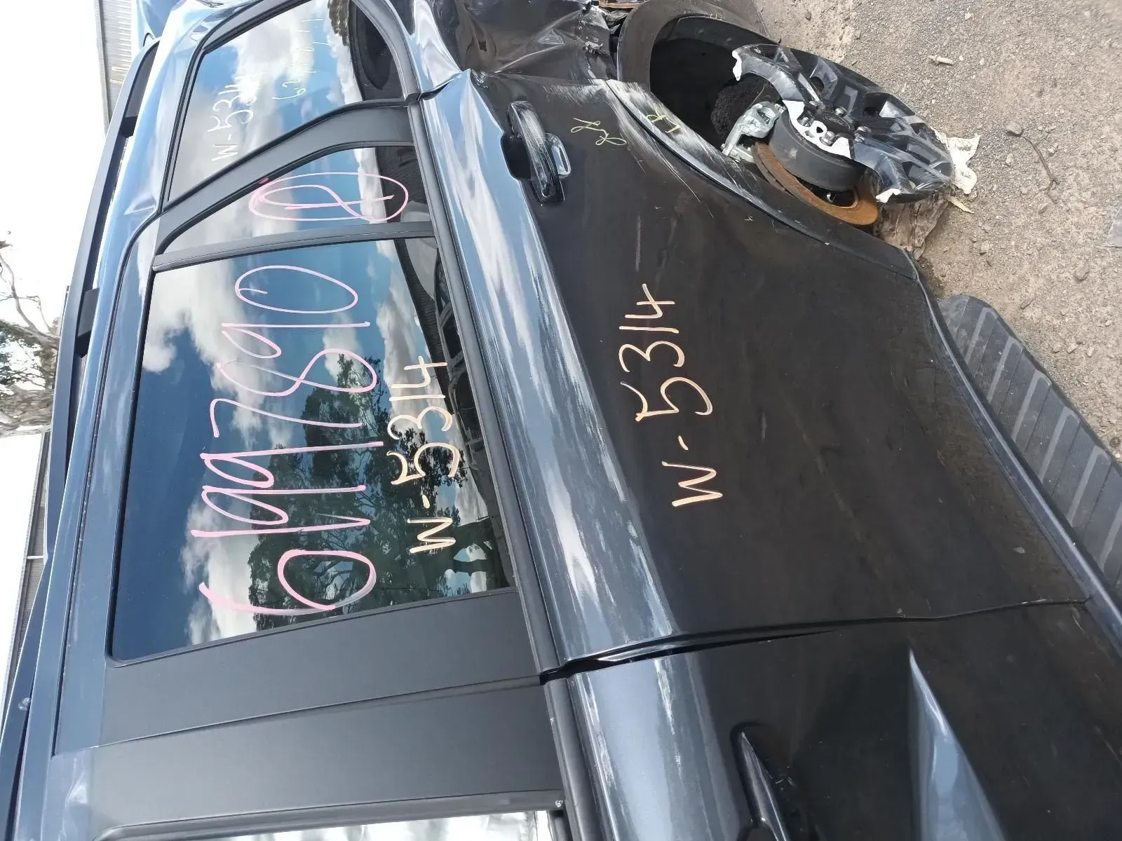 Black Suv at a Salvage Yard, Marked With Pink and White Numbers — South West 4WD Wreckers In Brisbane, QLD