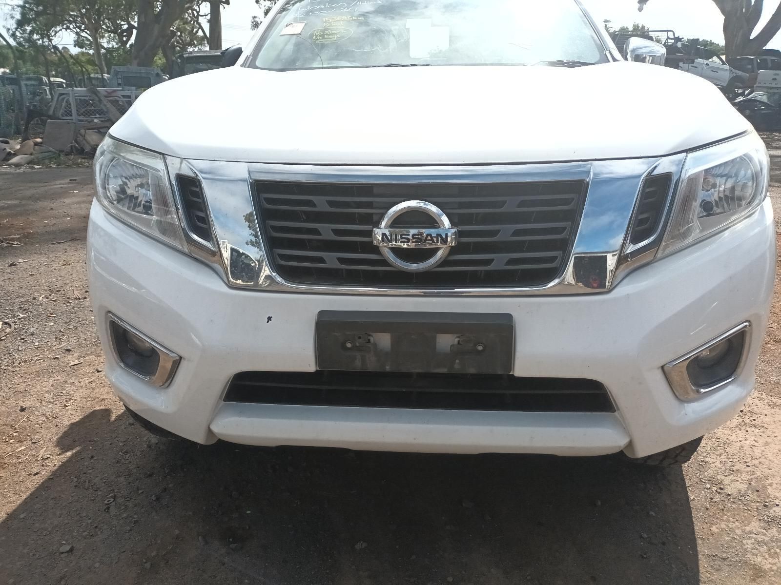 A White Nissan Truck is Parked on a Dirt Road — South West 4WD Wreckers in Harristown, QLD 