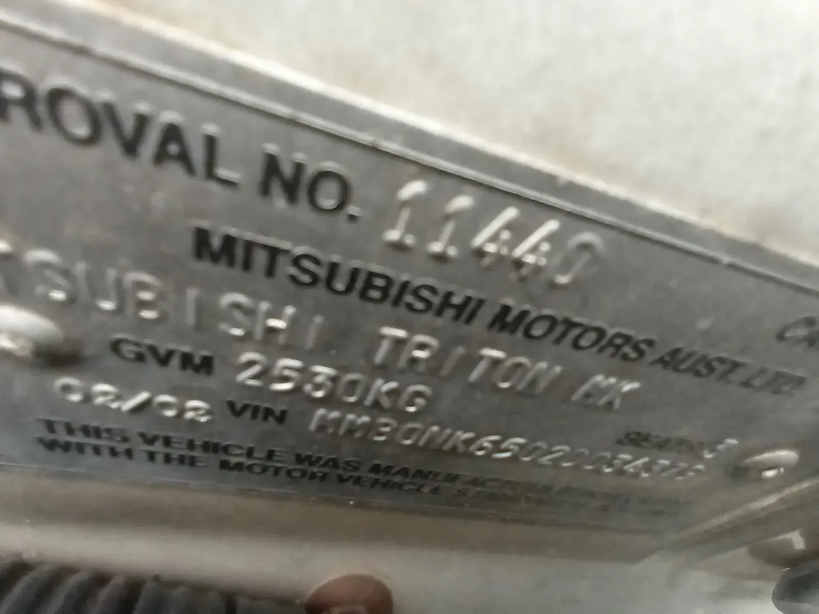 Close-up of a Mitsubishi Triton Mk Vehicle Information Plate — South West 4WD Wreckers In Brisbane, QLD