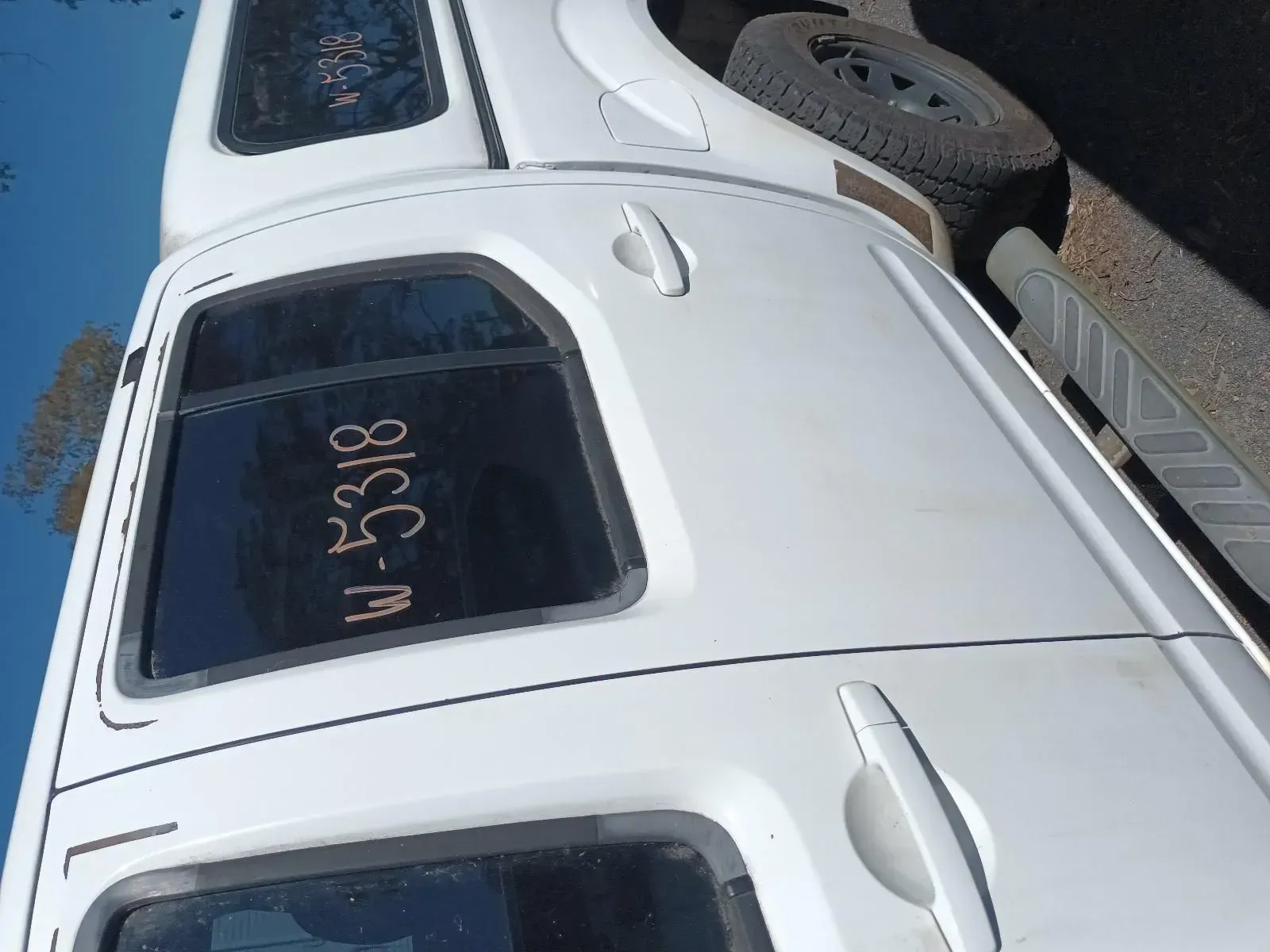 White Truck With Camper Shell, Spare Tyre Visible — South West 4WD Wreckers In Brisbane, QLD