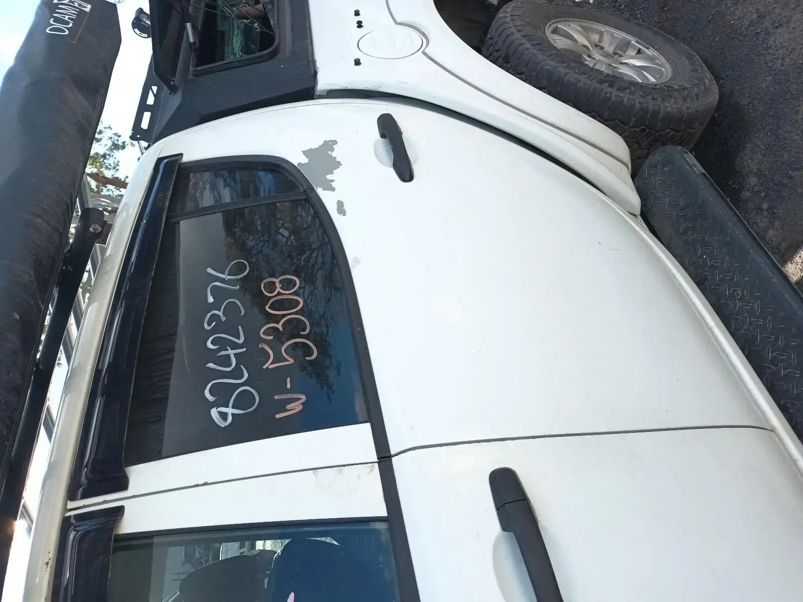 White Pickup Truck Side With Markings on the Window at a Salvage Yard — South West 4WD Wreckers In Brisbane, QLD