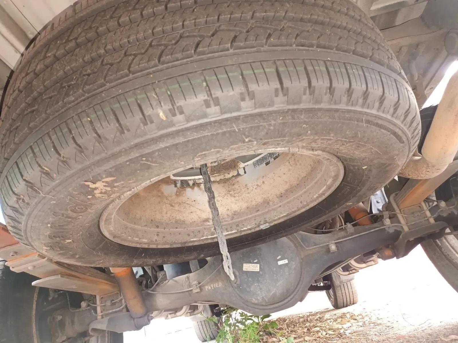 Spare Tyre Mounted Under a Vehicle's Bed, Visible Rear Axle — South West 4WD Wreckers In Brisbane, QLD