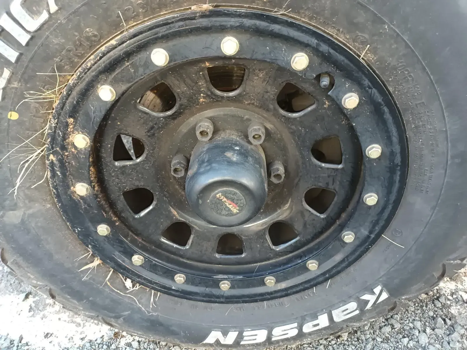 Black Off-road Vehicle Wheel With Silver Bolts, Black Hubcap, and Kapson Tyre — South West 4WD Wreckers In Brisbane, QLD