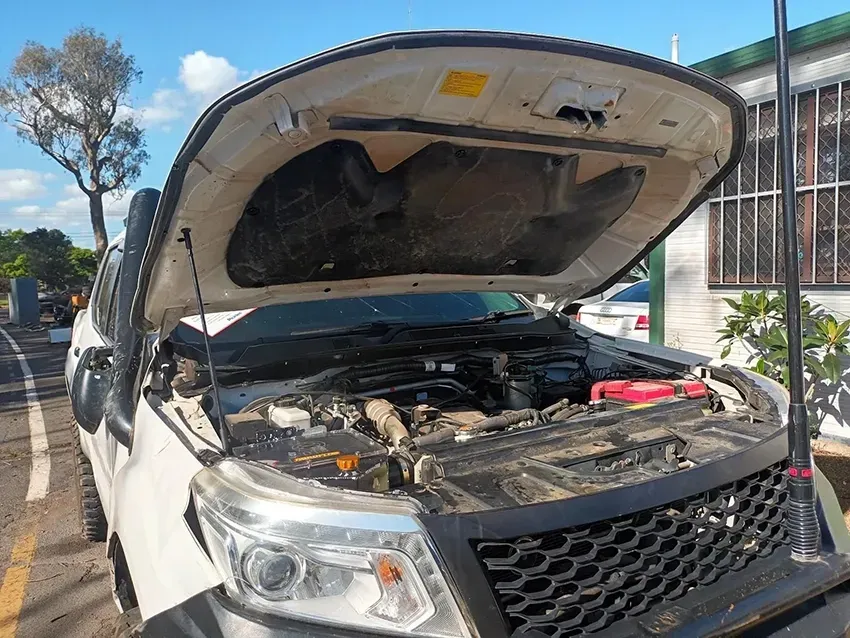 A White Truck with the Hood Open is Parked in a Parking Lot — South West 4WD Wreckers In Brisbane, QLD