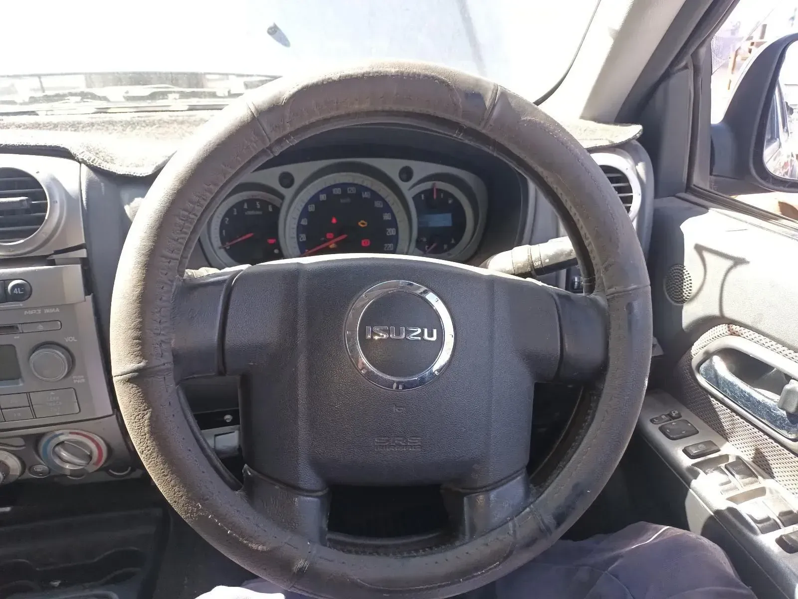 Steering Wheel of an Isuzu Car With Visible Gauges and Dashboard — South West 4WD Wreckers In Brisbane, QLD