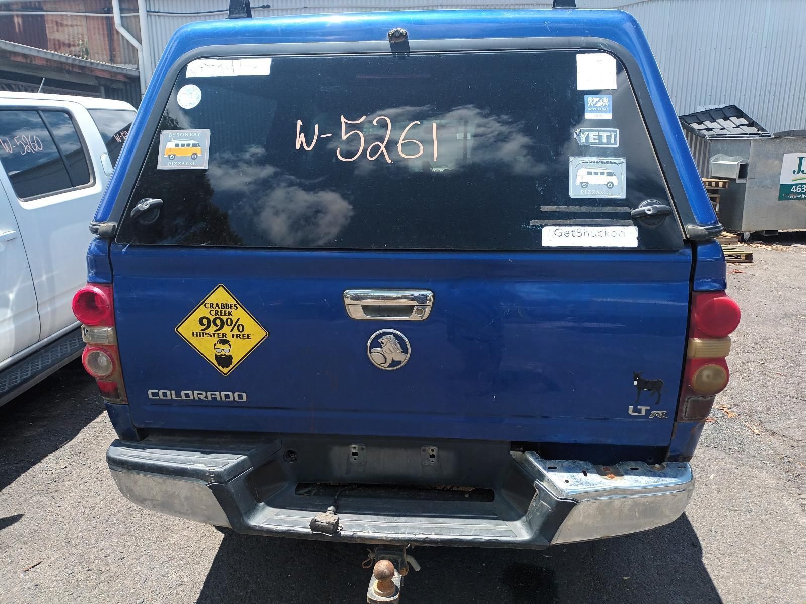 The Back of a Blue Truck with a Yellow Sign on It — South West 4WD Wreckers in Harristown, QLD