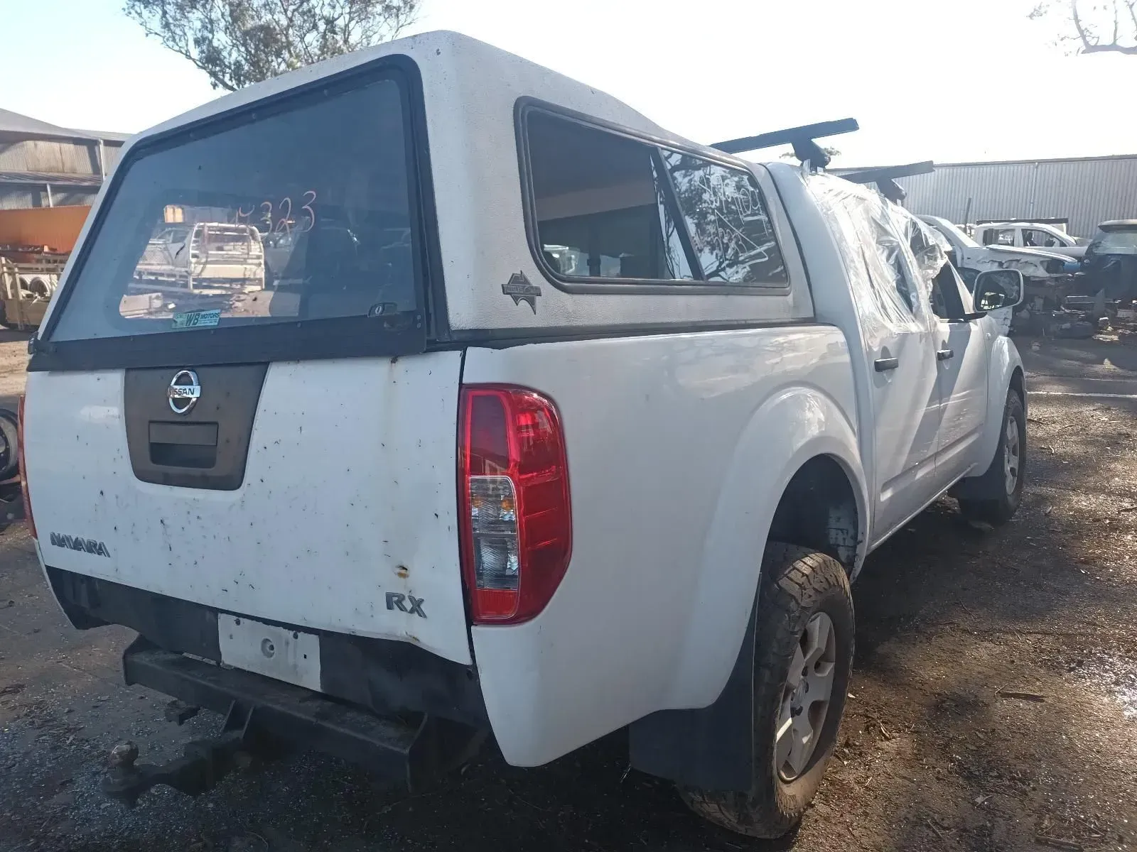 White Nissan Navara Pickup Truck With a Canopy — South West 4WD Wreckers In Brisbane, QLD