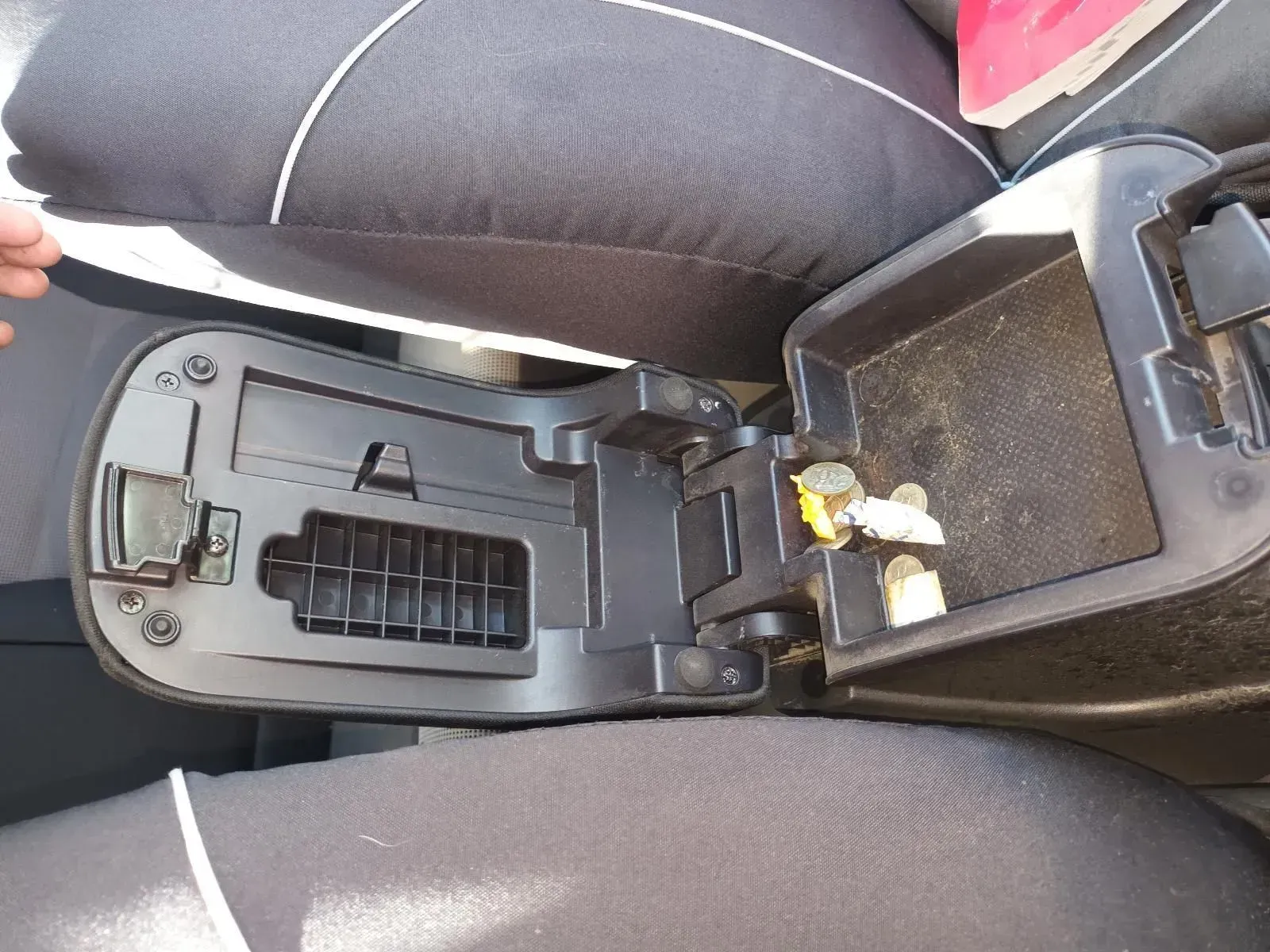Open Black Car Center Console With Debris Inside, Above Black Seats — South West 4WD Wreckers In Brisbane, QLD