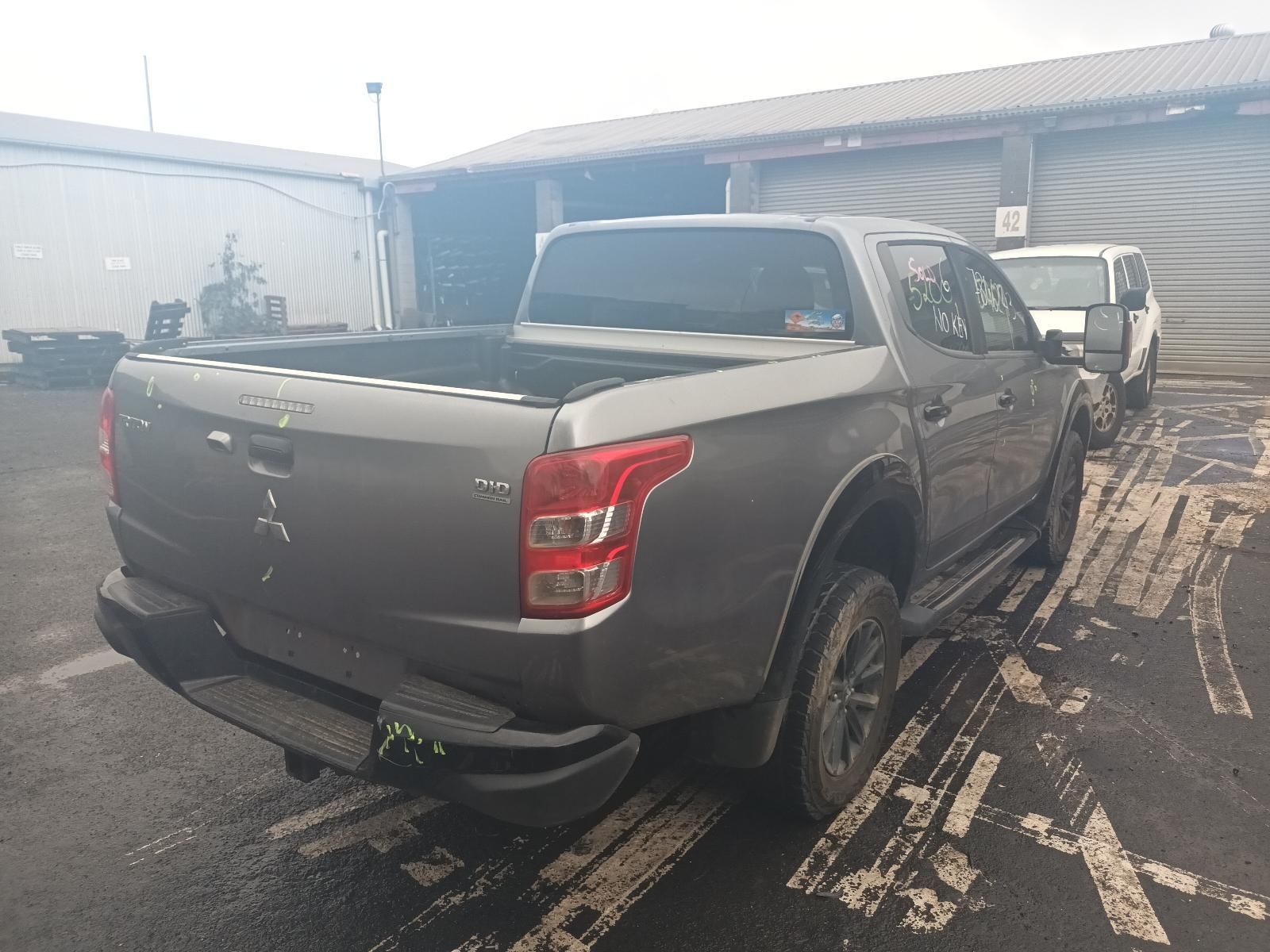 A Gray Truck is Parked in a Parking Lot in Front of a Building — South West 4WD Wreckers in Harristown, QLD 