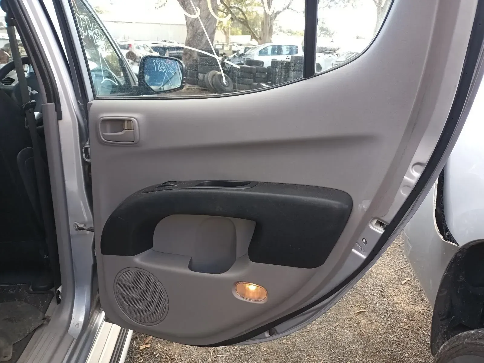 Gray Car Door Interior With Black Armrest, Speaker, and Light — South West 4WD Wreckers In Brisbane, QLD