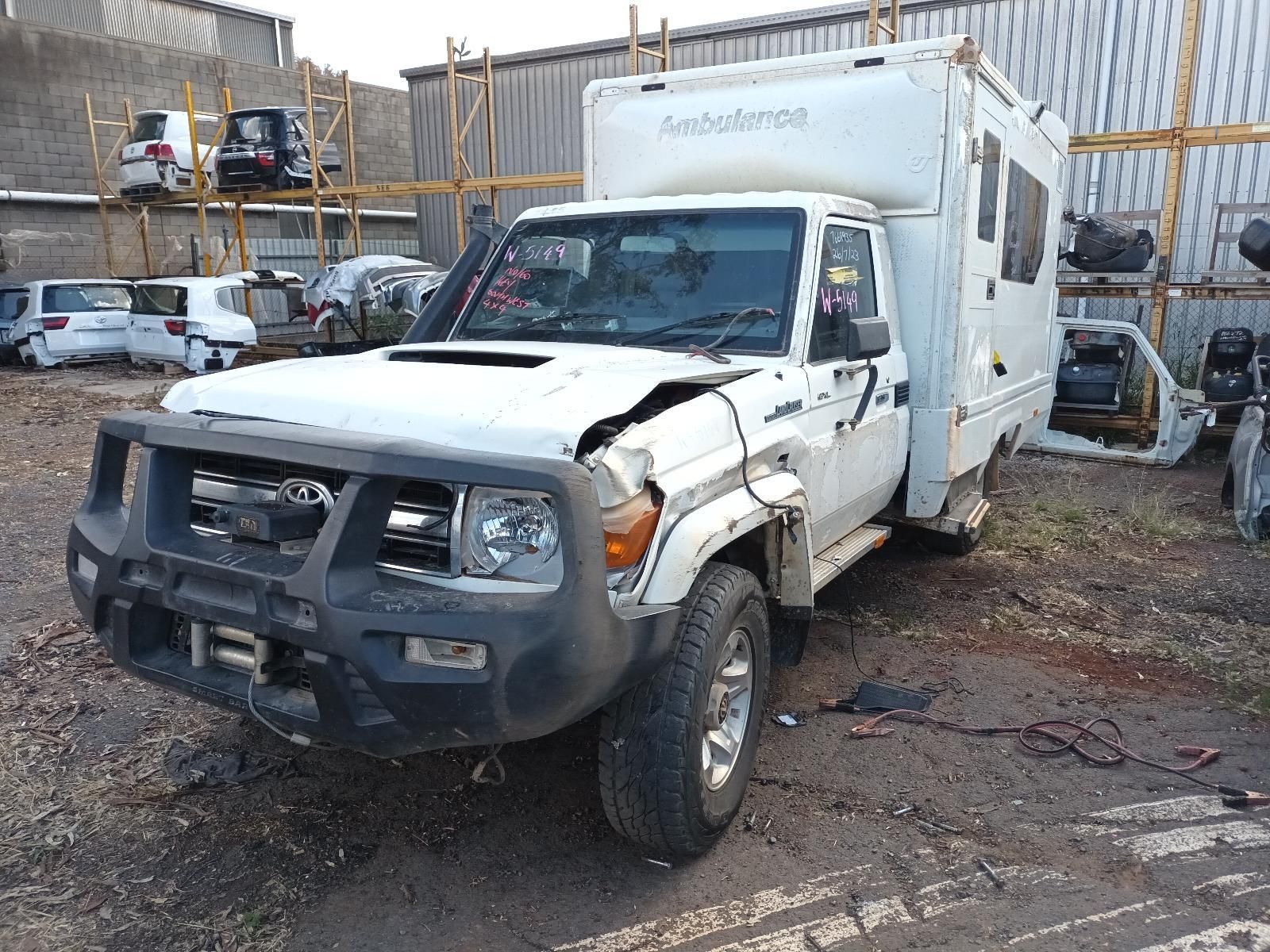 A White Truck with a Trailer Attached to It is Parked in a Parking Lot — South West 4WD Wreckers in Harristown, QLD 