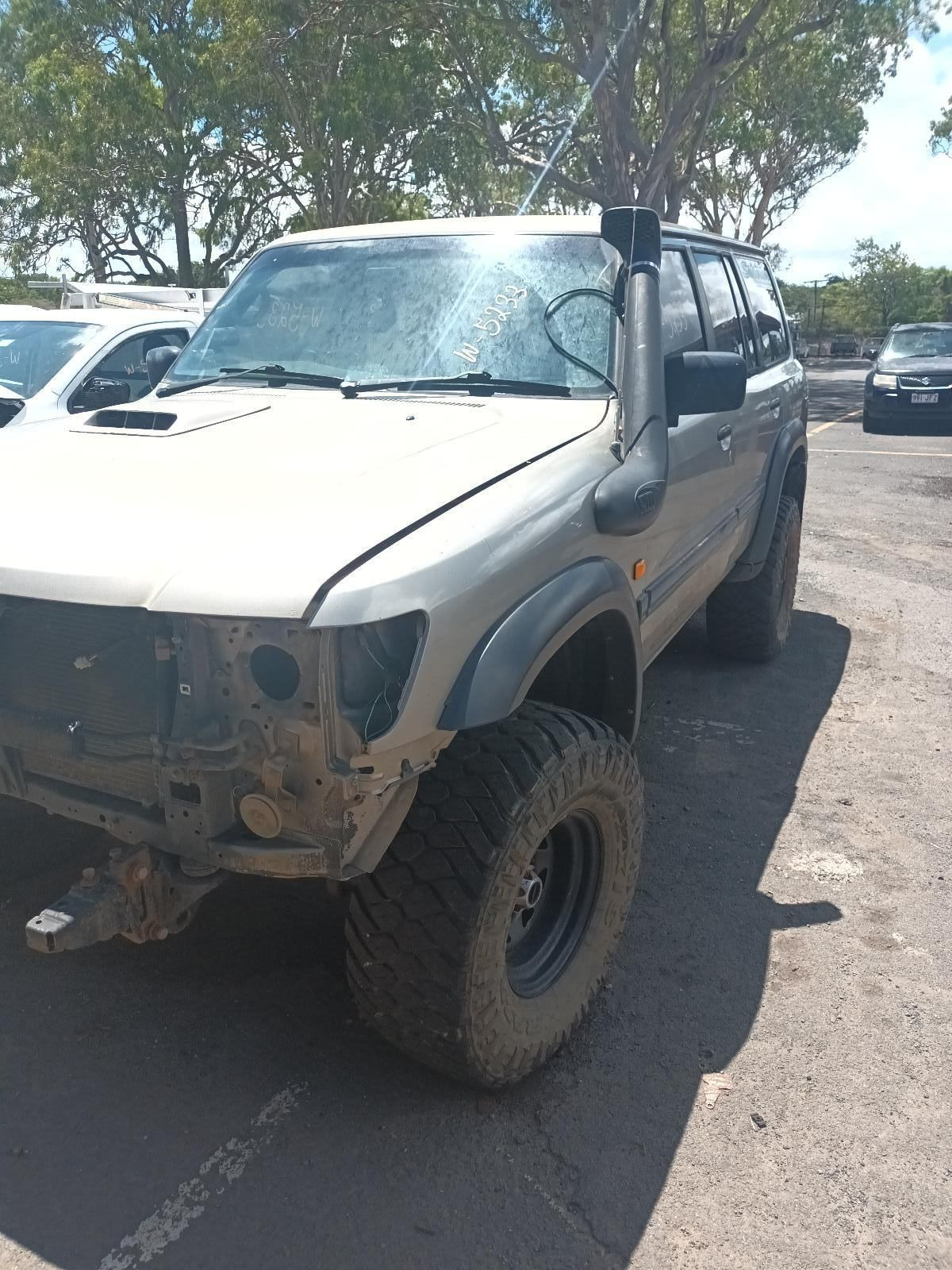 A White Truck is Parked on the Side of the Road — South West 4WD Wreckers In Brisbane, QLD